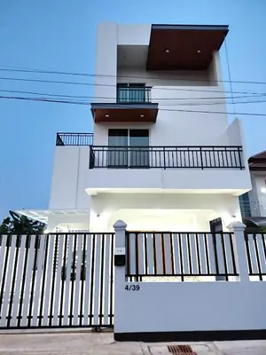 a white building with a balcony on it at Hidden Gems Residence in Ban Sala Daeng