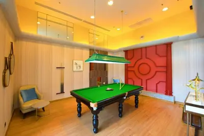 a pool table in a room with a red wall at Supalai Wellington 2, near MRT in Sathani Khlong Tan
