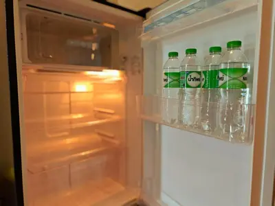 an open refrigerator filled with bottles of soda at BTS sukhumvit Line onnut station in Bangkok