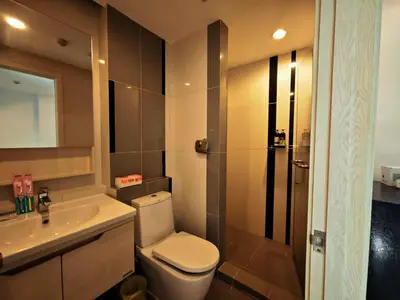 a bathroom with a toilet and a sink and a shower at BTS sukhumvit Line onnut station in Bangkok
