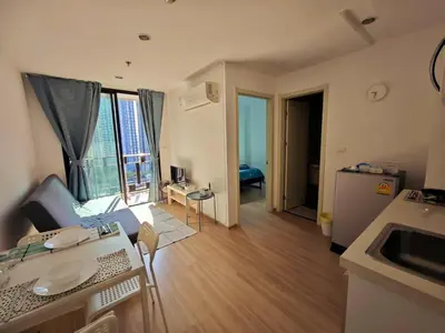 a room with a kitchen and a living room with a table at BTS sukhumvit Line onnut station in Bangkok