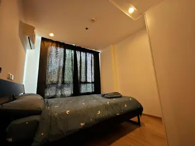 a bedroom with a bed in front of a window at BTS sukhumvit Line onnut station in Bangkok