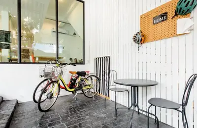 a bike parked next to a table and chairs at Homemade Ice cream house in local village in Bangkok