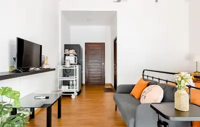 a living room with a couch and a tv at Homemade Ice cream house in local village in Bangkok