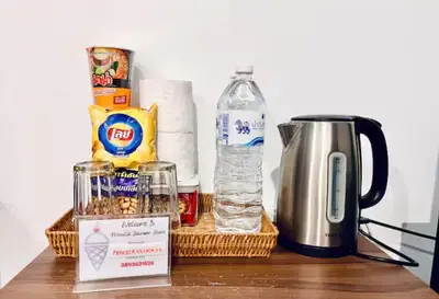 a basket with a coffee maker and a water bottle at Homemade Ice cream house in local village in Bangkok