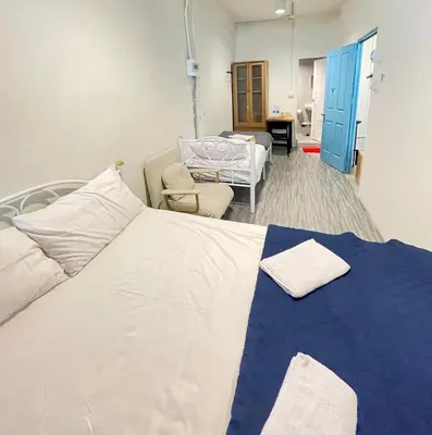 a hospital room with a bed and a chair at Moon Pīti in Bangkok