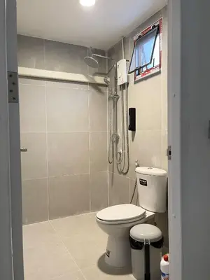 a bathroom with a shower and a toilet at Moon Pīti in Bangkok