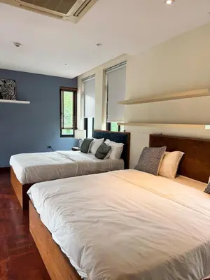 two beds in a room with blue walls at Central BKK Luxuxy Pool Villa 4BR in Bangkok