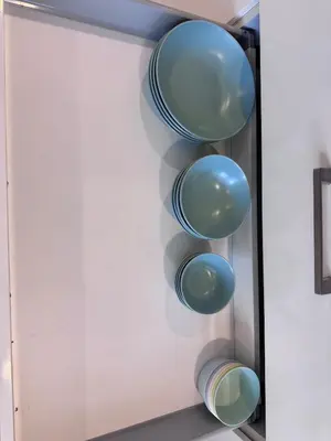 a shelf in a kitchen with blue bowls at Central BKK Luxuxy Pool Villa 4BR in Bangkok