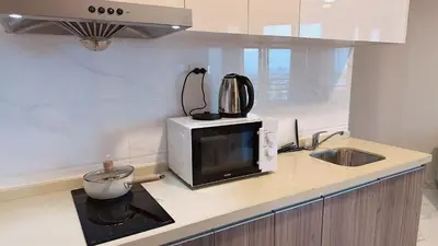 a kitchen counter with a microwave and a sink at Artisan Ratchada Prime Studio Condos in Bangkok