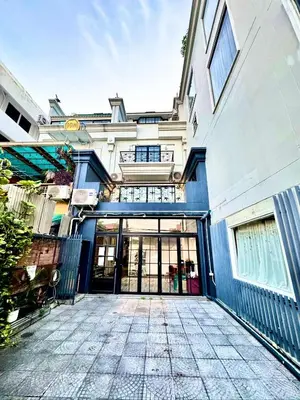 a building with a large glass door in front of it at Old Town Heritage Lofts Bangkok in Bangkok