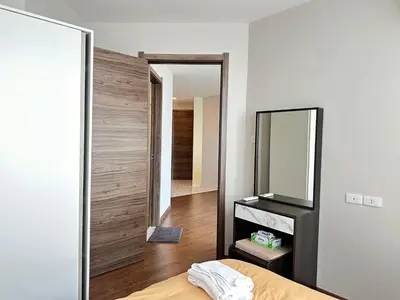 a bedroom with a mirror and a bed at Artisan Ratchada Huge 1BR Condos in Bangkok