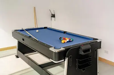 a pool table with balls on top of it at The Lodge Bangkok Poolvilla in Sathani Khlong Tan