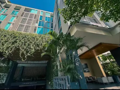 a building with palm trees in front of it at 2 Bed 2 Bath Phrom Phong BTS in Bangkok