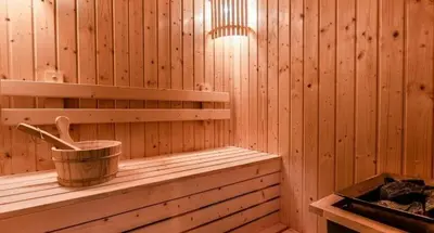 a wooden sauna with a bucket on a shelf at Paradise condo-perfect location in Bangkok