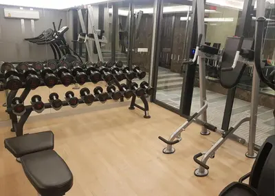 a gym with a row of racks of equipment at Paradise condo-perfect location in Bangkok