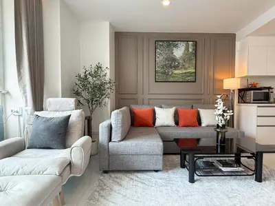 a living room with a couch and a table at Spacious City 69 SQM - Fast WiFi - BTS Chong Nonsi in Bangkok