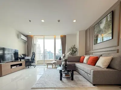 a living room with a couch and a television at Spacious City 69 SQM - Fast WiFi - BTS Chong Nonsi in Bangkok