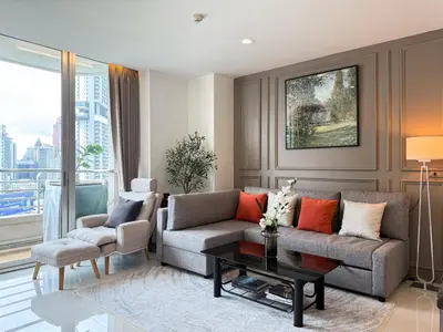 a living room with a couch and a table at Spacious City 69 SQM - Fast WiFi - BTS Chong Nonsi in Bangkok