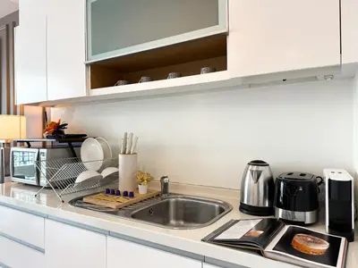 a kitchen with a sink and a counter top at Spacious City 69 SQM - Fast WiFi - BTS Chong Nonsi in Bangkok