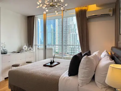 a bedroom with a bed with a large window at Spacious City 69 SQM - Fast WiFi - BTS Chong Nonsi in Bangkok