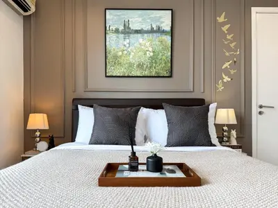 a bedroom with a bed with a tray on it at Spacious City 69 SQM - Fast WiFi - BTS Chong Nonsi in Bangkok