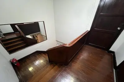 a stairway with a mirror and a stair case at Orchid Hostel Near Bumrungrad hospital and Nana Market in Bangkok