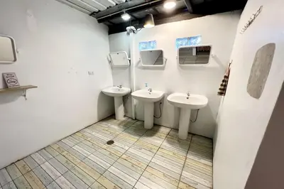 a bathroom with two sinks and two mirrors at Orchid Hostel Near Bumrungrad hospital and Nana Market in Bangkok
