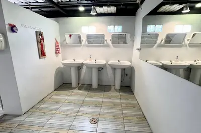a bathroom with four sinks in a room at Orchid Hostel Near Bumrungrad hospital and Nana Market in Bangkok