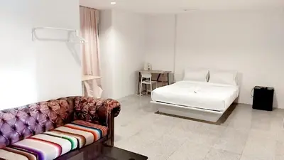 a living room with a couch and a bed at xx Mitr INN Sukhumvit 2 - BTS Nana มิตร อินน์ สุขุมวิทซอย 2 บีทีเอส นานา in Bangkok