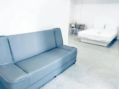 a blue couch and a bed in a room at xx Mitr INN Sukhumvit 2 - BTS Nana มิตร อินน์ สุขุมวิทซอย 2 บีทีเอส นานา in Bangkok