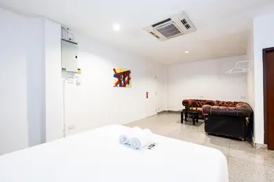 a living room with a couch at xx Mitr INN Sukhumvit 2 - BTS Nana มิตร อินน์ สุขุมวิทซอย 2 บีทีเอส นานา in Bangkok