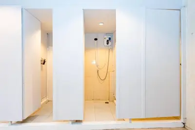 a bathroom with a mirror and a shower stall at xx Mitr INN Sukhumvit 2 - BTS Nana มิตร อินน์ สุขุมวิทซอย 2 บีทีเอส นานา in Bangkok