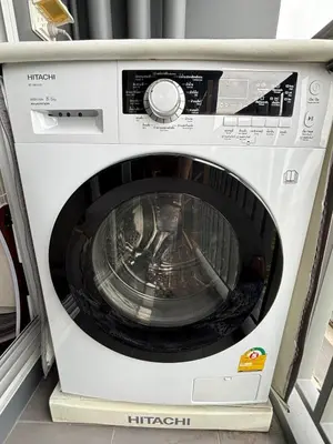 a white washing machine sitting on a shelf at Nich Mono Ramkhumheng Low Rise in Sathani Ban Hua Mak