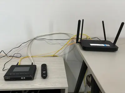two laptops and remotes sitting on a table at Nich Mono Ramkhumheng Low Rise in Sathani Ban Hua Mak
