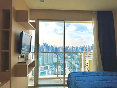 a bedroom with a large window with a view of a city at Super City View Room, Swimming Pool,Gym,150m walk to BTS in Bangkok
