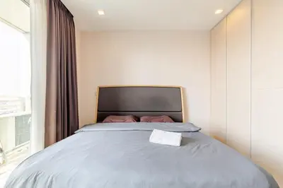 a bed in a small room with a window at Super City View Room, Swimming Pool,Gym,150m walk to BTS in Bangkok