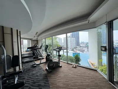 a gym with tread machines and a view of the water at Super City View Room, Swimming Pool,Gym,150m walk to BTS in Bangkok