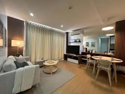 a living room with a couch and a table at 6th Avenue Sukhumvit BKK 301 BTS Asoke Nana MRT in Bangkok