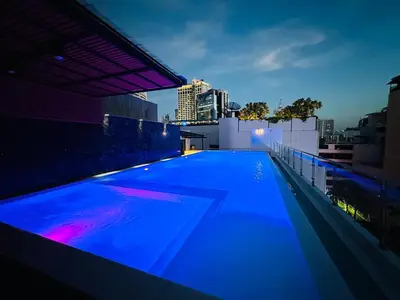 a blue swimming pool on the roof of a building at 6th Avenue Sukhumvit BKK 301 BTS Asoke Nana MRT in Bangkok