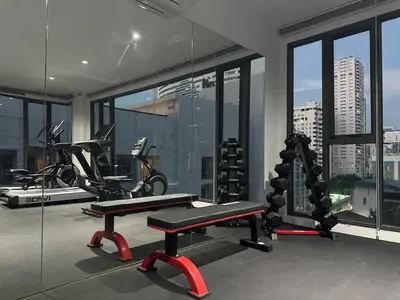 a gym with two bikes and a bench in a room at 6th Avenue Sukhumvit BKK 301 BTS Asoke Nana MRT in Bangkok