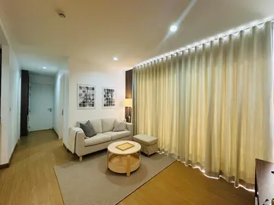 a living room with a couch and a table at 6th Avenue Sukhumvit BKK 301 BTS Asoke Nana MRT in Bangkok