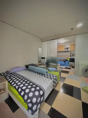 a bedroom with a bed and a checkered floor at Condo with Pool View & Great Amenities Bangkok in Sathani Ban Hua Mak