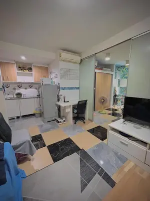 a room with a kitchen and a living room with a floor at Condo with Pool View & Great Amenities Bangkok in Sathani Ban Hua Mak