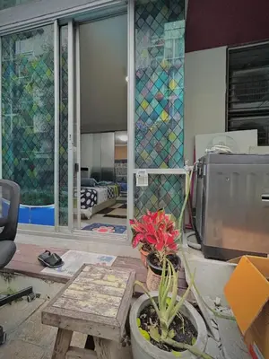 a living room with a stained glass window and a tv at Condo with Pool View & Great Amenities Bangkok in Sathani Ban Hua Mak