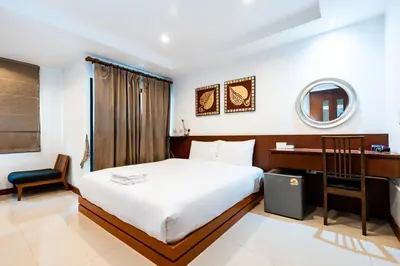 a bedroom with a bed and a desk and a mirror at XX YON INN - Sukhumvit 4 BTS NANA in Bangkok