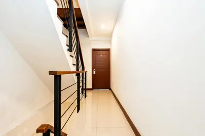 a hallway with stairs leading to a door at XX YON INN - Sukhumvit 4 BTS NANA in Bangkok