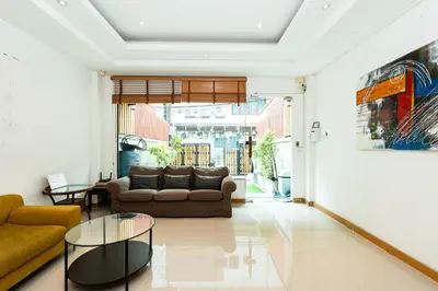 a living room with a couch and a table at XX YON INN - Sukhumvit 4 BTS NANA in Bangkok