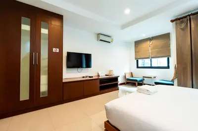 a hotel room with a bed and a tv at XX YON INN - Sukhumvit 4 BTS NANA in Bangkok