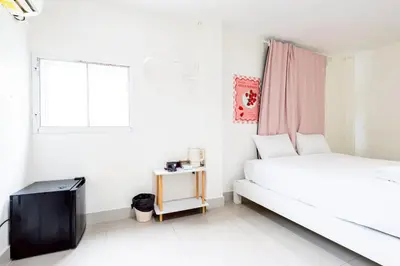 a white bedroom with a bed and a window at XX Oh My Nap- Sukhumvit Soi 3 BTS Nana in Bangkok